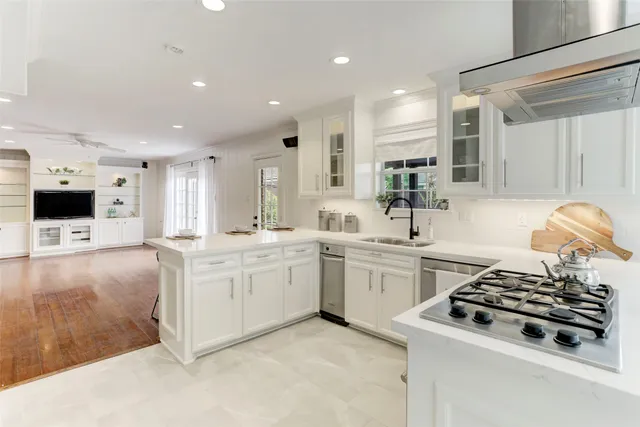 a kitchen with sink stove and refrigerator