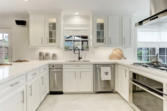a kitchen with sink stove and cabinets