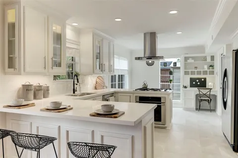 a kitchen with stainless steel appliances kitchen island granite countertop a sink and cabinets