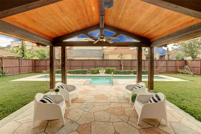 a view of a patio with a table chairs and a backyard