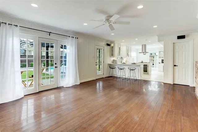 a view of large kitchen with large windows and refrigerator