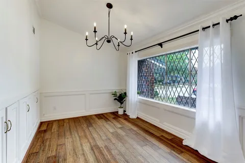 a view of a room with wooden floor cabinets and a window