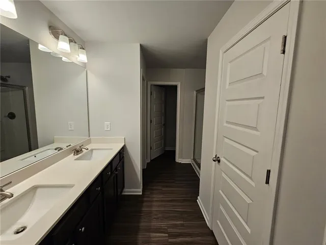 a bathroom with a double vanity sink and a mirror