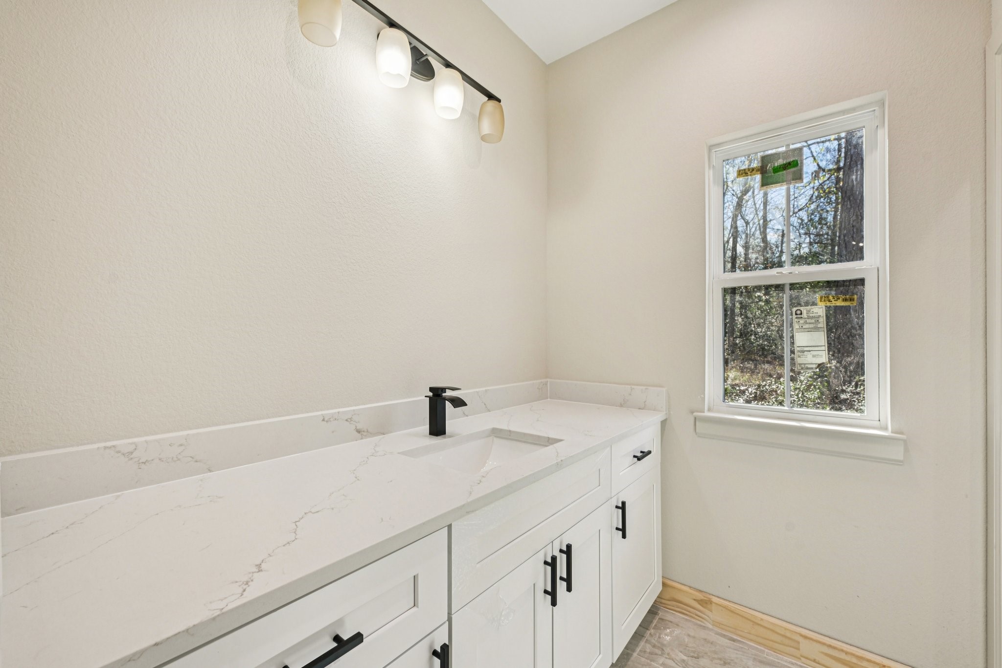15132 Coaltown Road Willis, TX 77378 - Photo 17 of 29 This bathroom features a sleek design with quartz countertop, modern black fixtures.