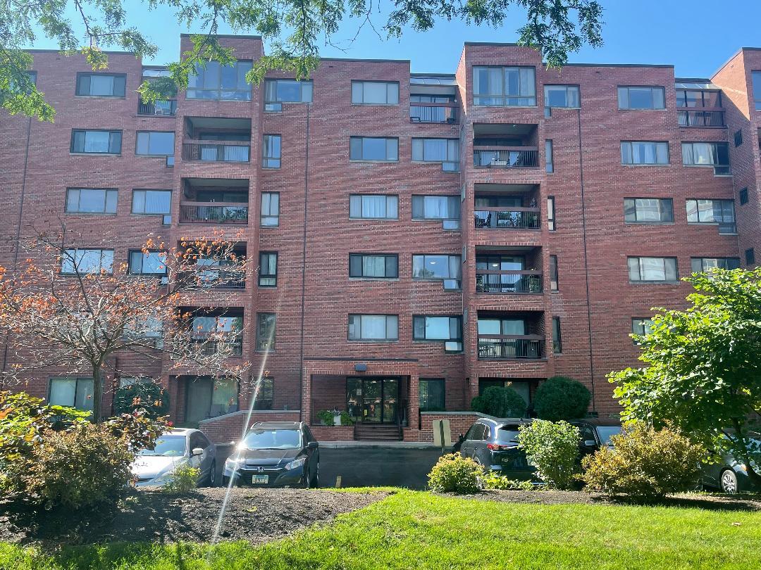 3801 Appian Way, Unit 302 Glenview, IL 60025 - Photo 1 of 16 a front view of a building with garden