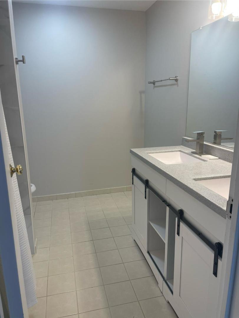 3801 Appian Way, Unit 302 Glenview, IL 60025 - Photo 12 of 16 a bathroom with a sink and vanity