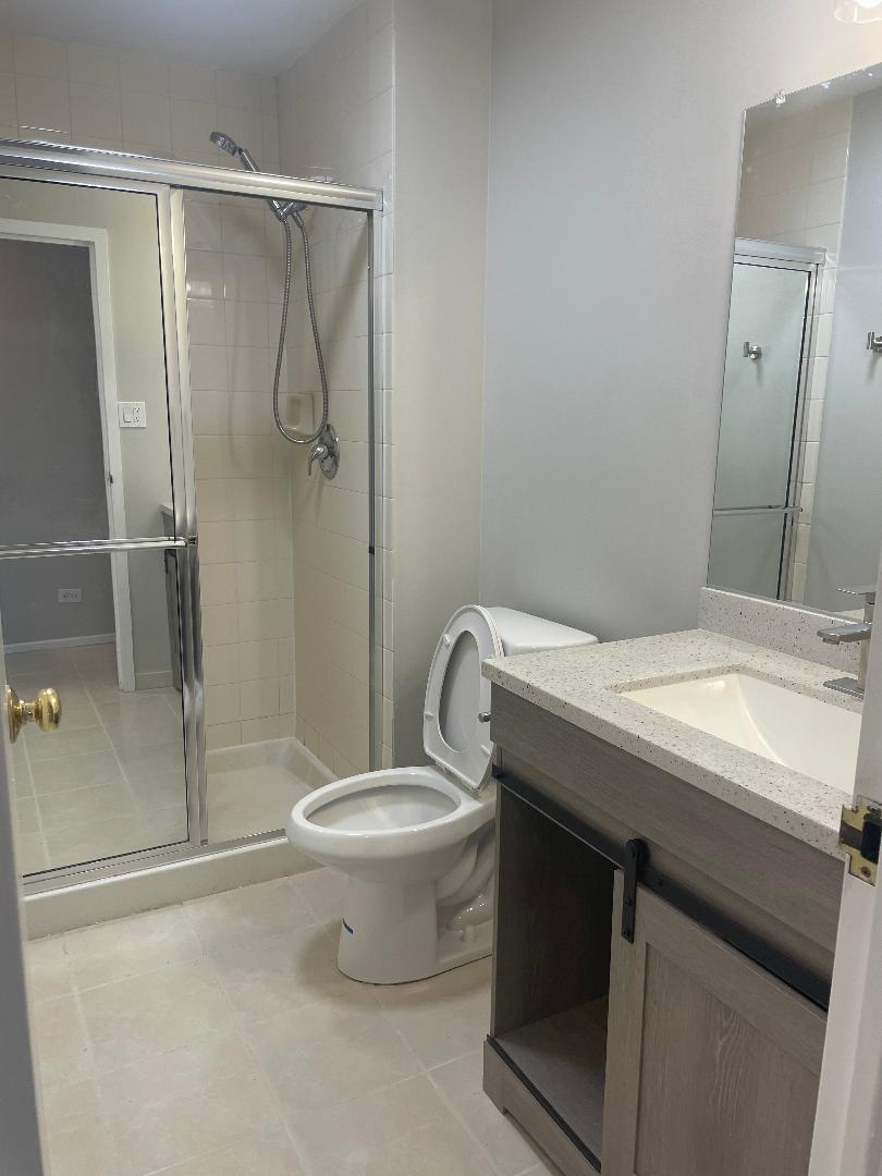 3801 Appian Way, Unit 302 Glenview, IL 60025 - Photo 14 of 16 a bathroom with a granite countertop sink toilet and shower