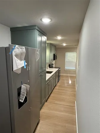 a kitchen with stainless steel appliances granite countertop a refrigerator and a sink
