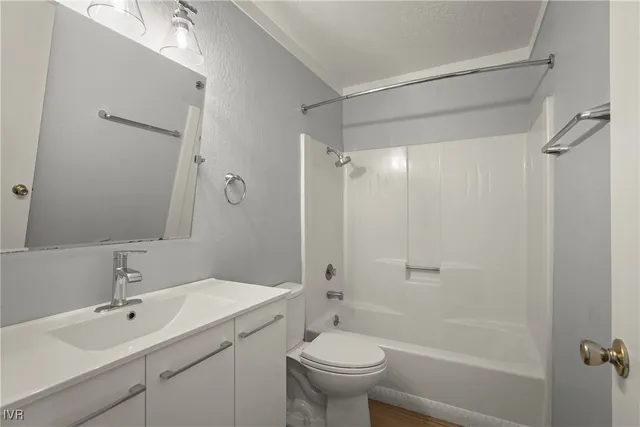 a bathroom with a sink toilet tub and shower