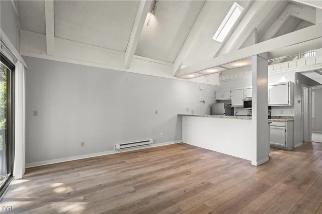 a view of a kitchen with wooden floor