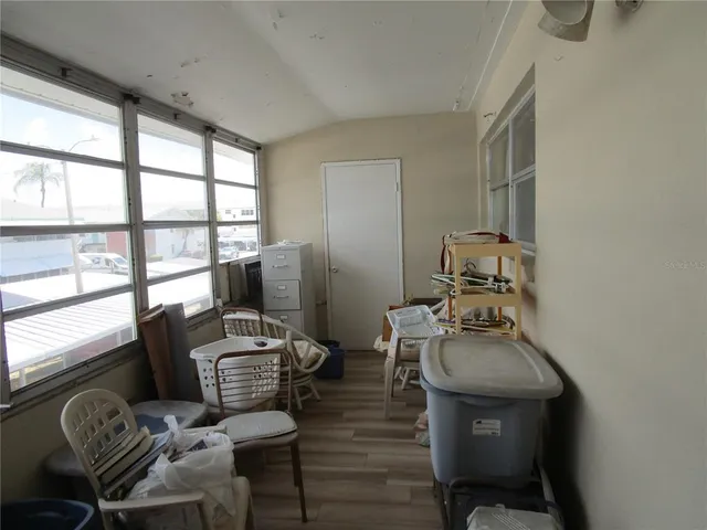 a view of a workspace with furniture and a window