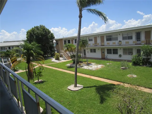 a front view of a house with a yard table and chairs
