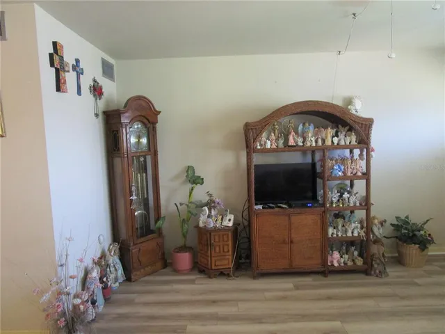 a view of a livingroom with wooden floor and furniture