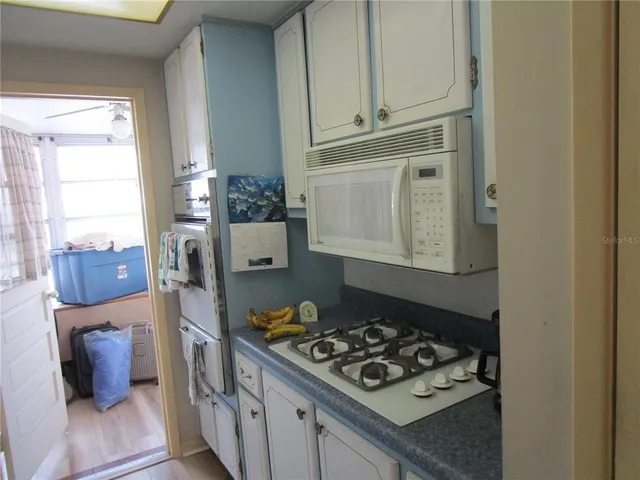 a kitchen with stainless steel appliances granite countertop a stove and a refrigerator