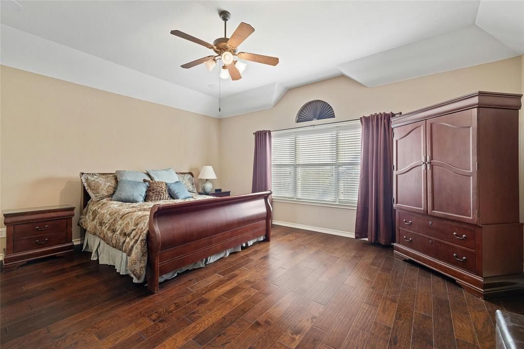 2603 White Stallion Way Leander, TX 78641 - Photo 18 of 38 a bedroom with a bed and a chandelier