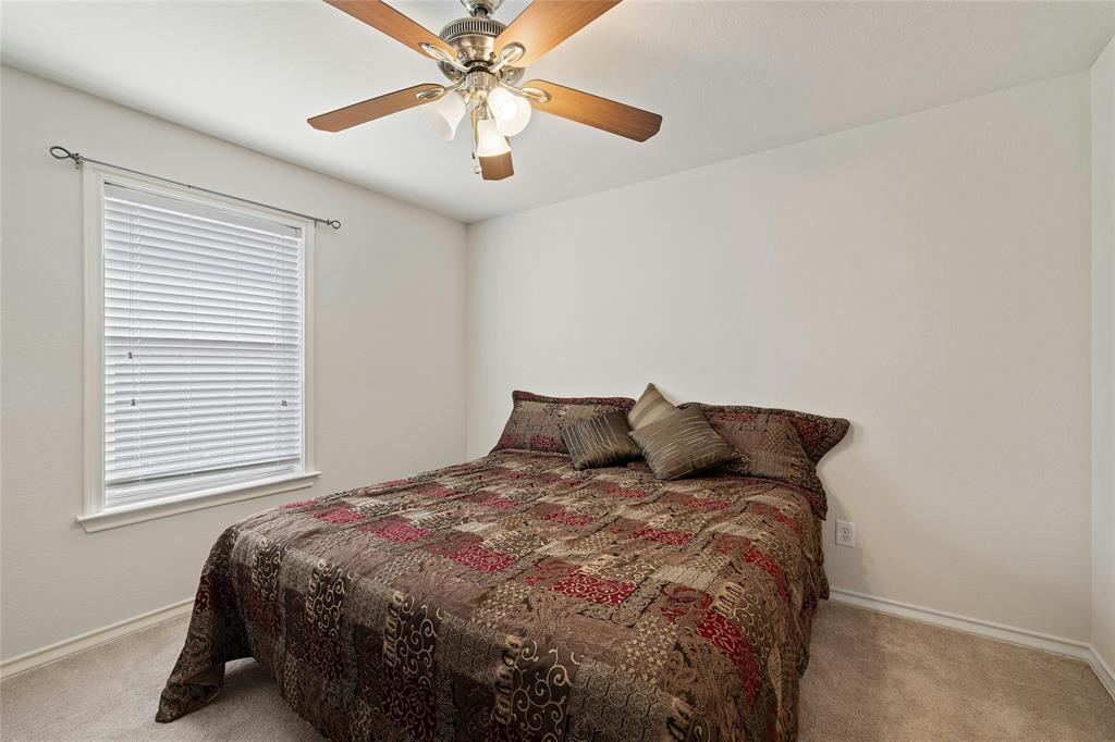 2603 White Stallion Way Leander, TX 78641 - Photo 22 of 38 a bed sitting in a bedroom next to a window
