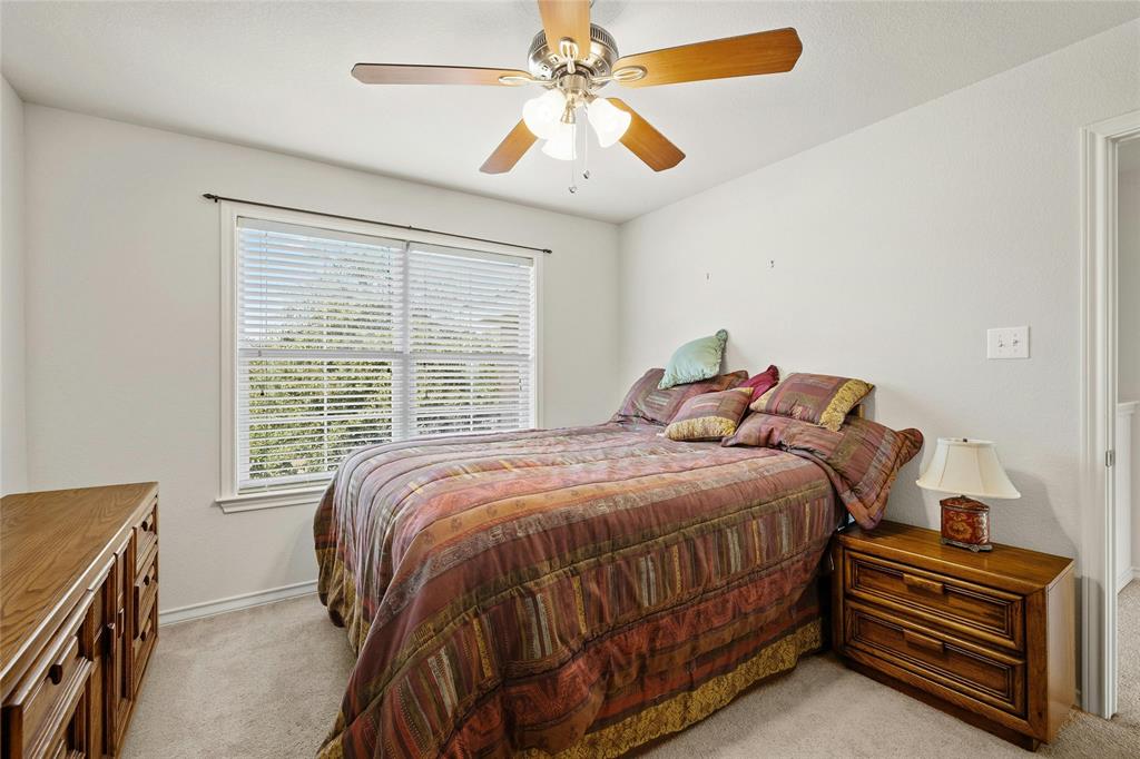 2603 White Stallion Way Leander, TX 78641 - Photo 26 of 38 a bedroom with a bed and a chandelier