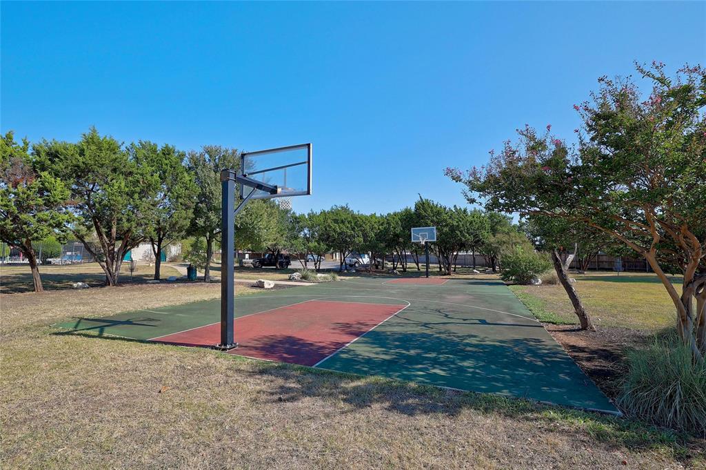 2603 White Stallion Way Leander, TX 78641 - Photo 36 of 38 a backyard of a house with table and chairs