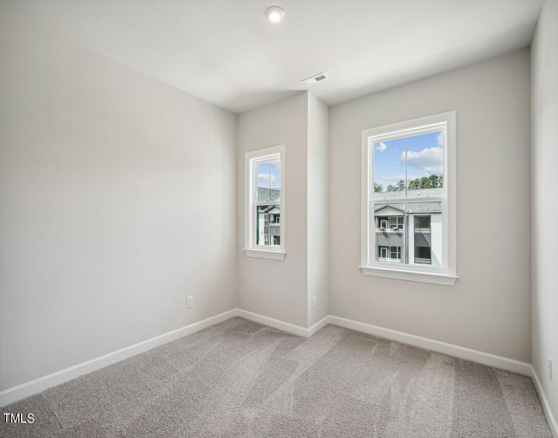 4816 Cypress Tree Lane Raleigh, NC 27612 - Photo 11 of 15 an empty room with a window