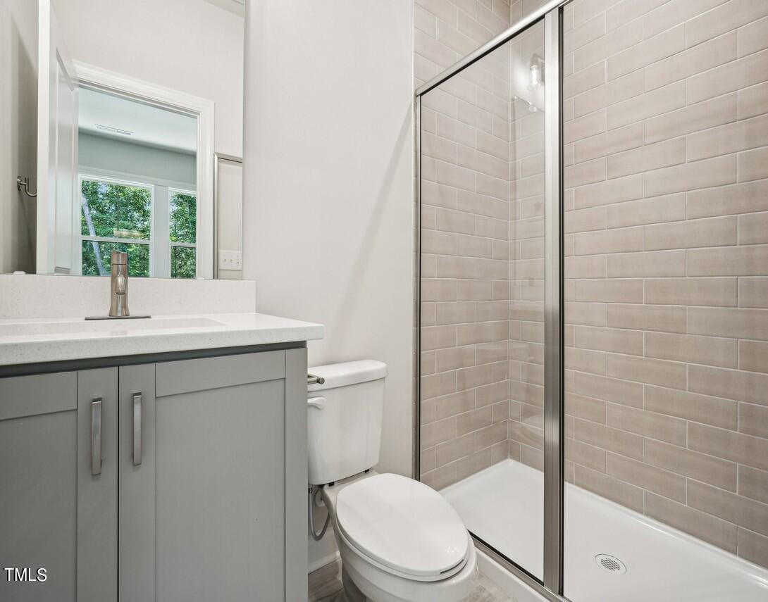 4816 Cypress Tree Lane Raleigh, NC 27612 - Photo 13 of 15 a bathroom with a sink a toilet and shower