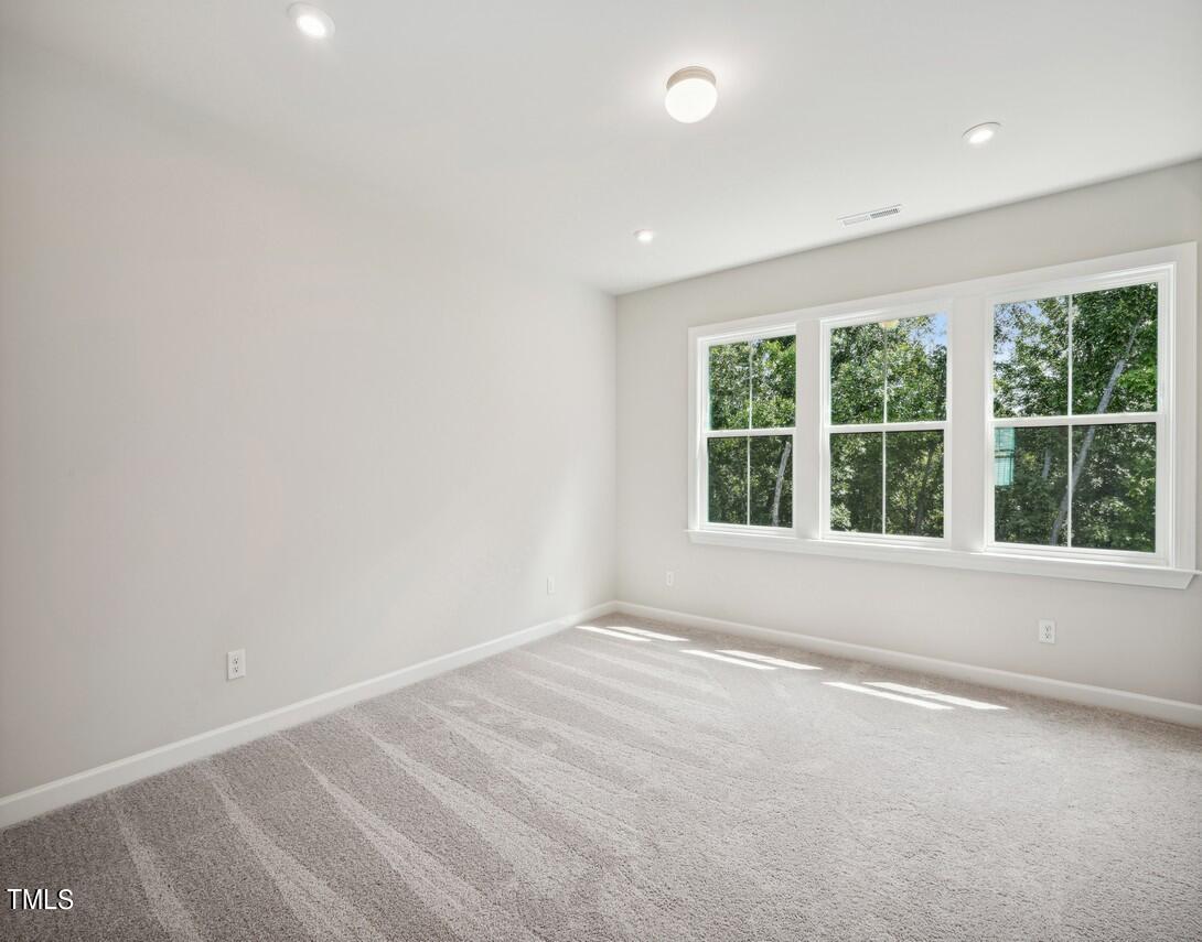 4816 Cypress Tree Lane Raleigh, NC 27612 - Photo 9 of 15 an empty room with large windows