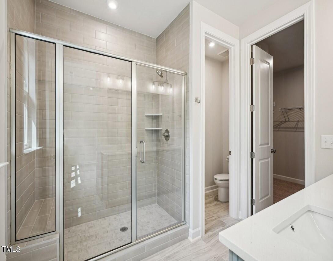 4816 Cypress Tree Lane Raleigh, NC 27612 - Photo 10 of 15 a bathroom with a shower and a sink