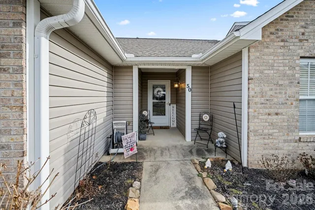 a view of a pathway of a house with backyard of the house