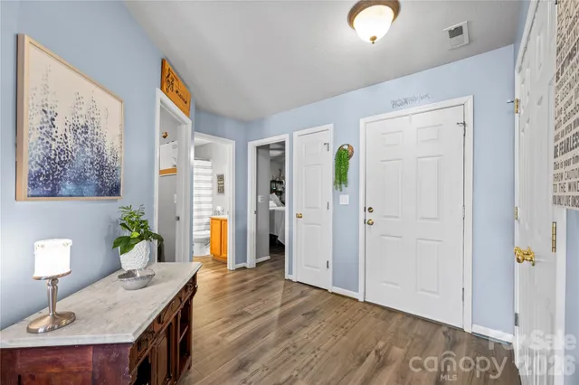 a view of a workspace with furniture and wooden floor