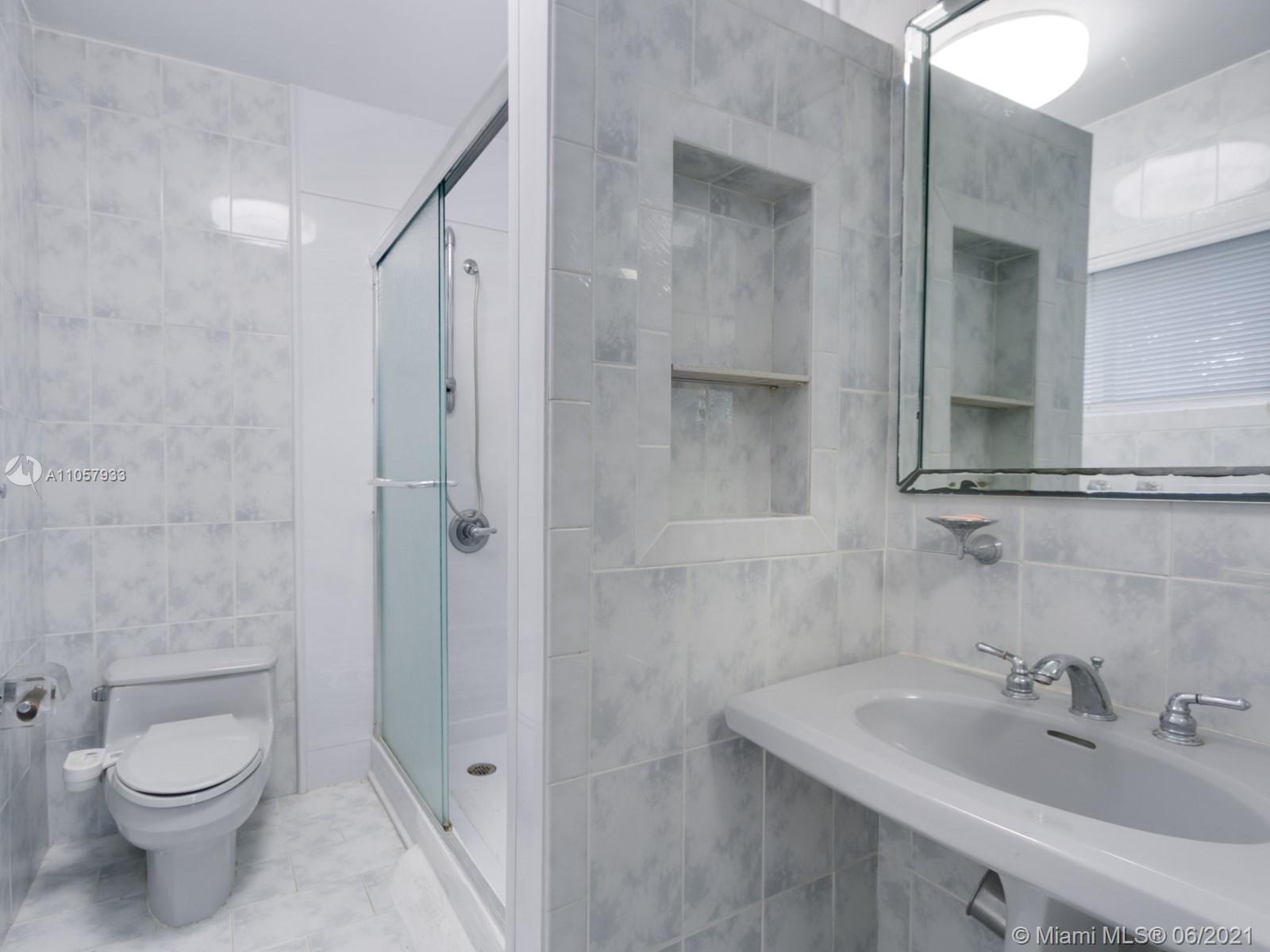 4708 Alton Road Miami Beach, FL 33140 - Photo 12 of 38 a bathroom with a sink toilet and shower