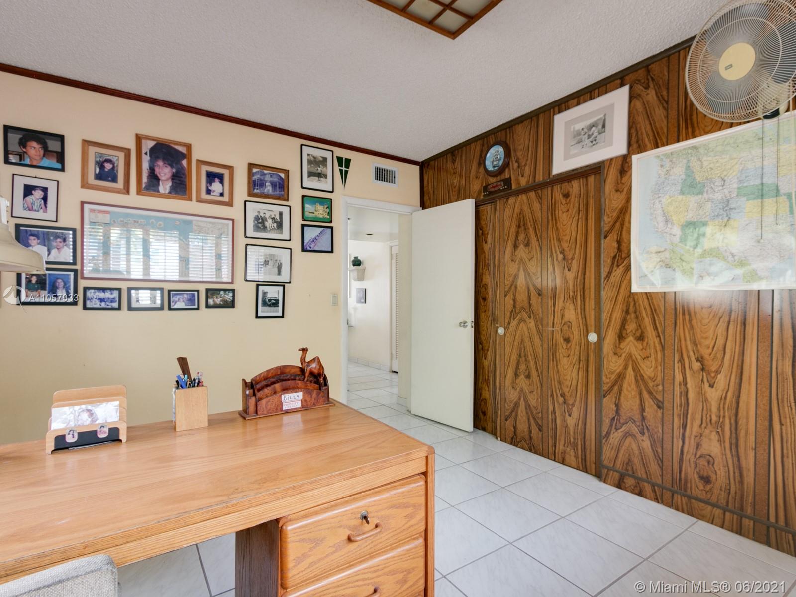 4708 Alton Road Miami Beach, FL 33140 - Photo 15 of 38 a bedroom with a bed and a cabinets