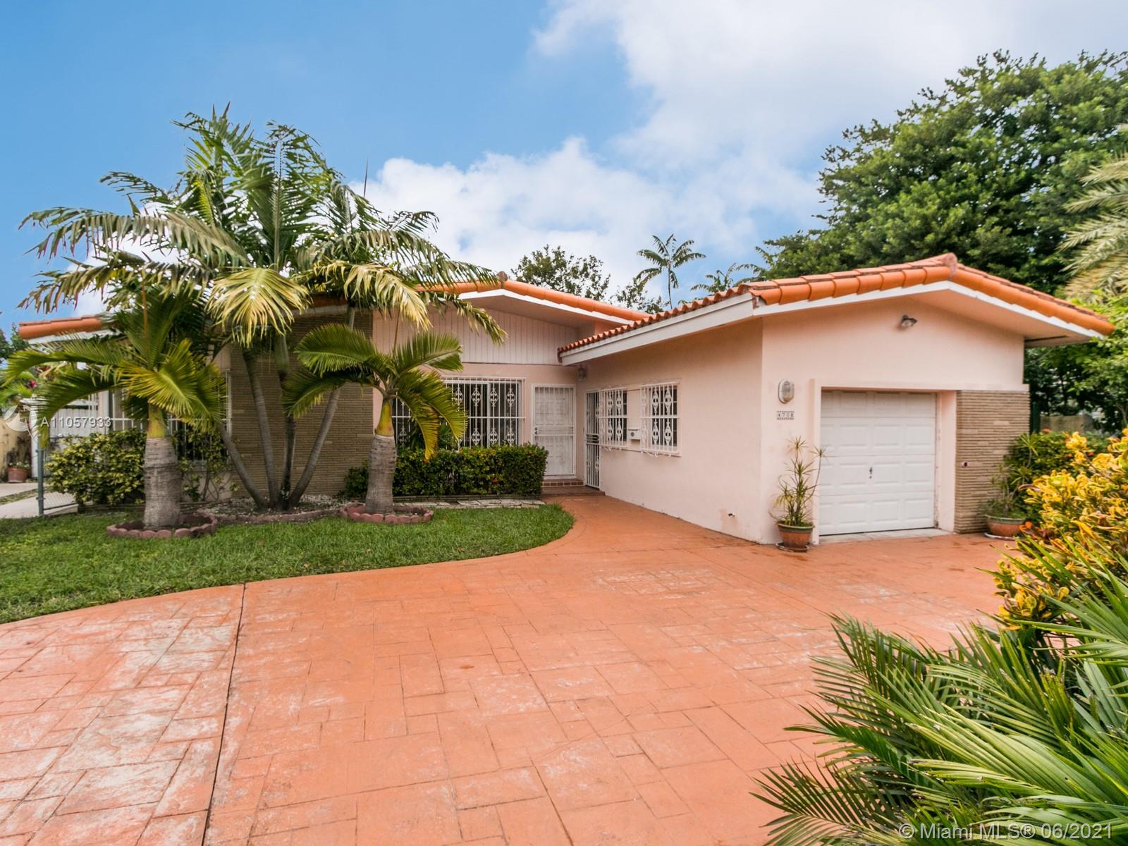 4708 Alton Road Miami Beach, FL 33140 - Photo 23 of 38 a view of a house with a yard and potted plants