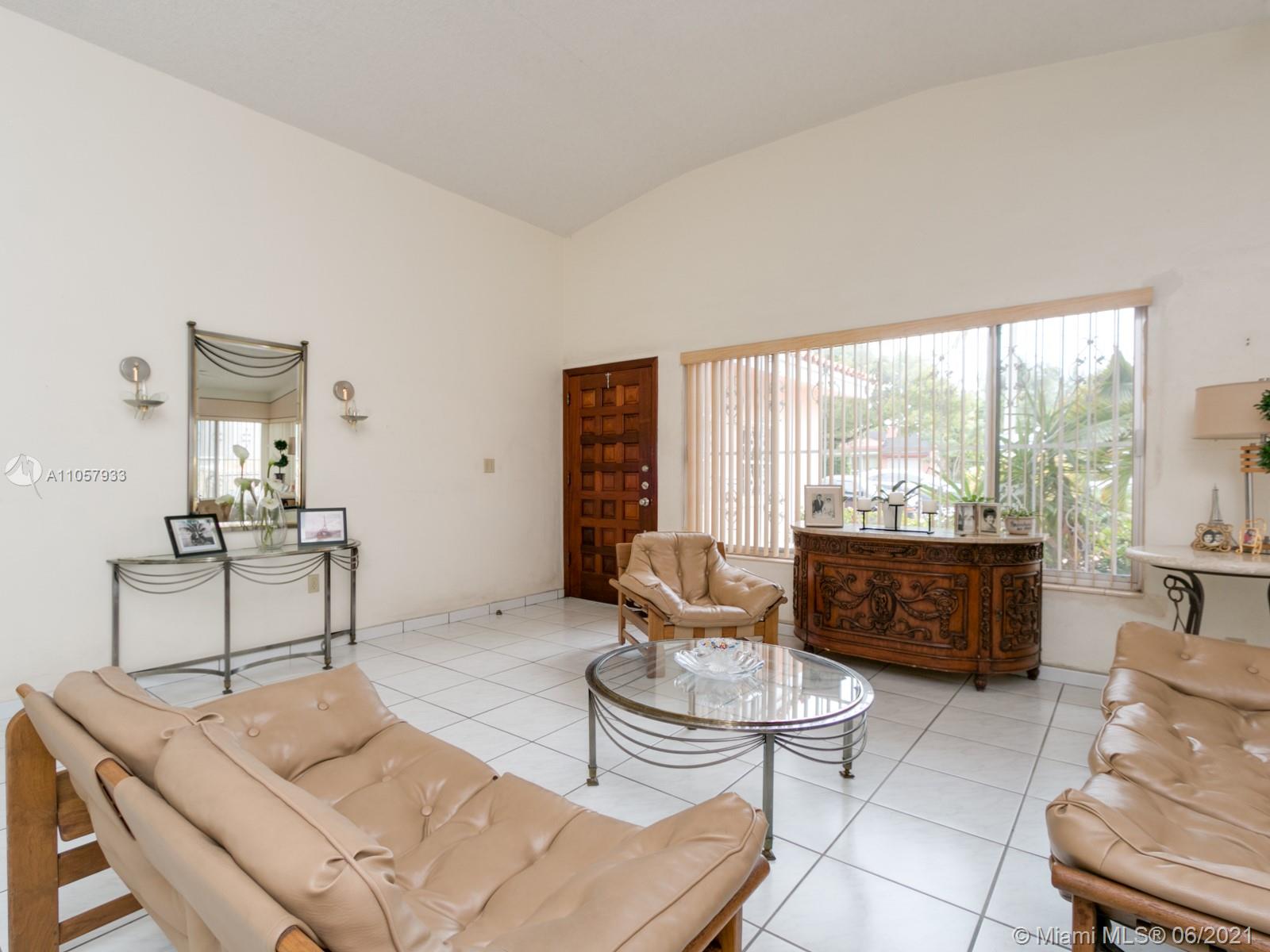 4708 Alton Road Miami Beach, FL 33140 - Photo 26 of 38 a living room with furniture and a large window