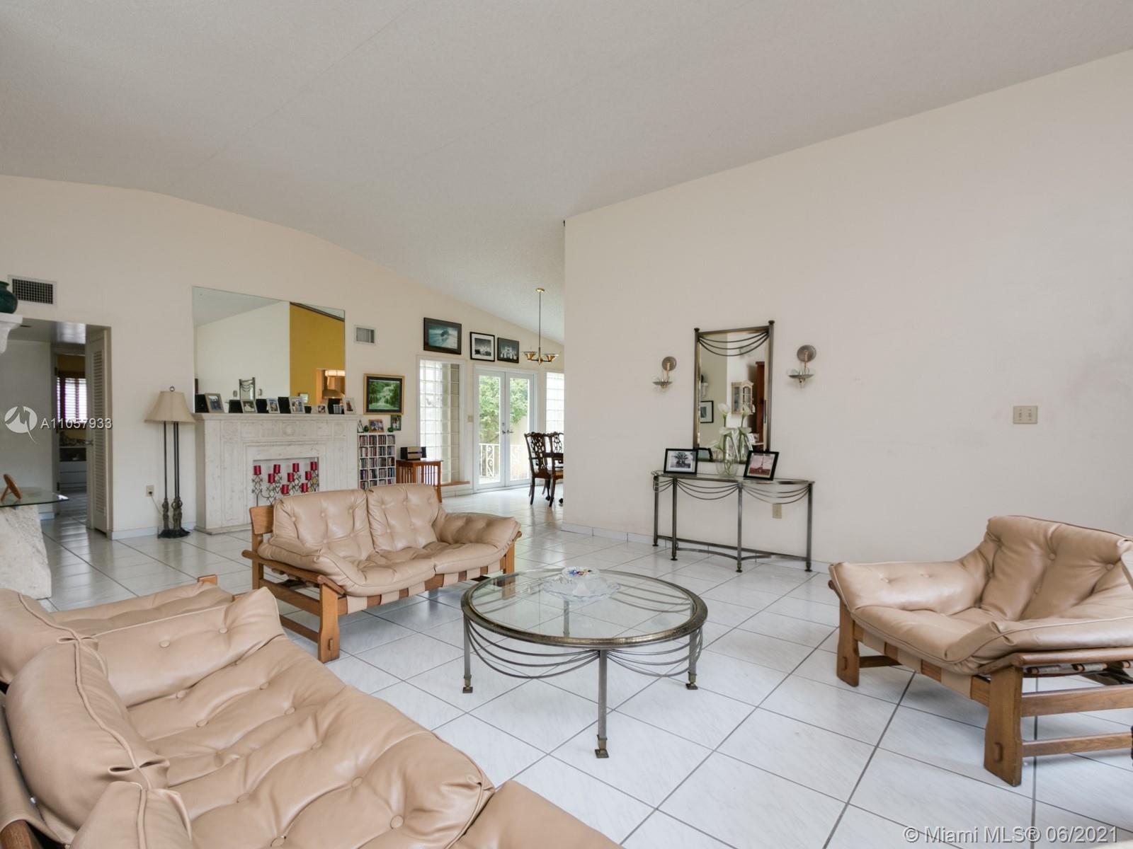 4708 Alton Road Miami Beach, FL 33140 - Photo 27 of 38 a living room with furniture and a table