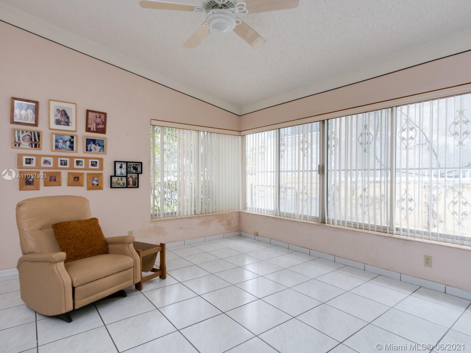 4708 Alton Road Miami Beach, FL 33140 - Photo 28 of 38 a living room with furniture and a large window
