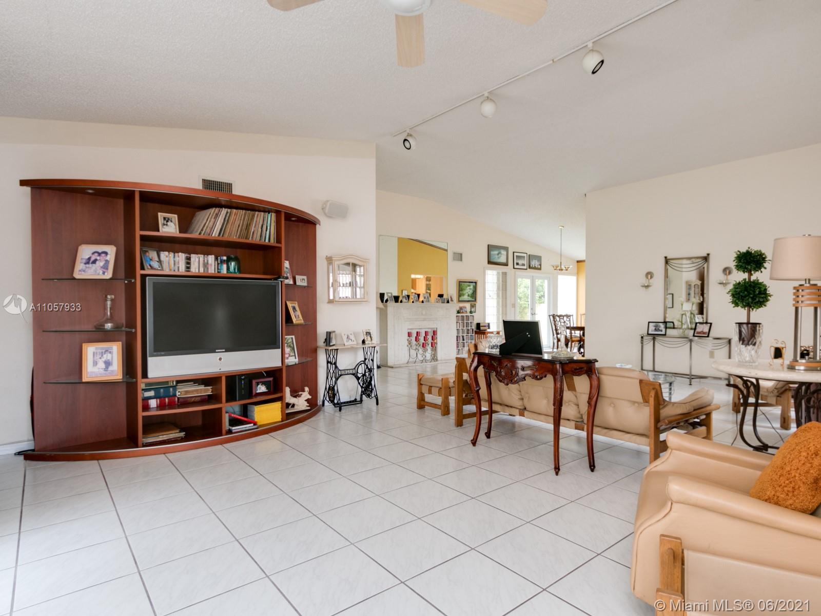 4708 Alton Road Miami Beach, FL 33140 - Photo 29 of 38 a living room with furniture and a flat screen tv