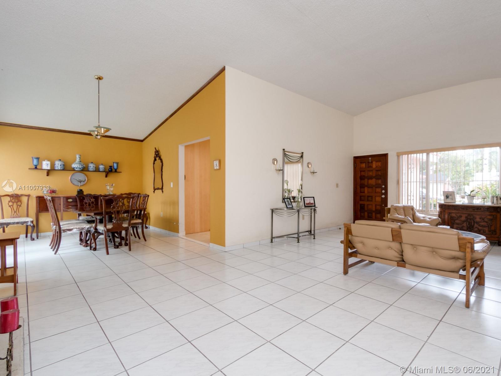4708 Alton Road Miami Beach, FL 33140 - Photo 31 of 38 a living room with furniture and a chandelier