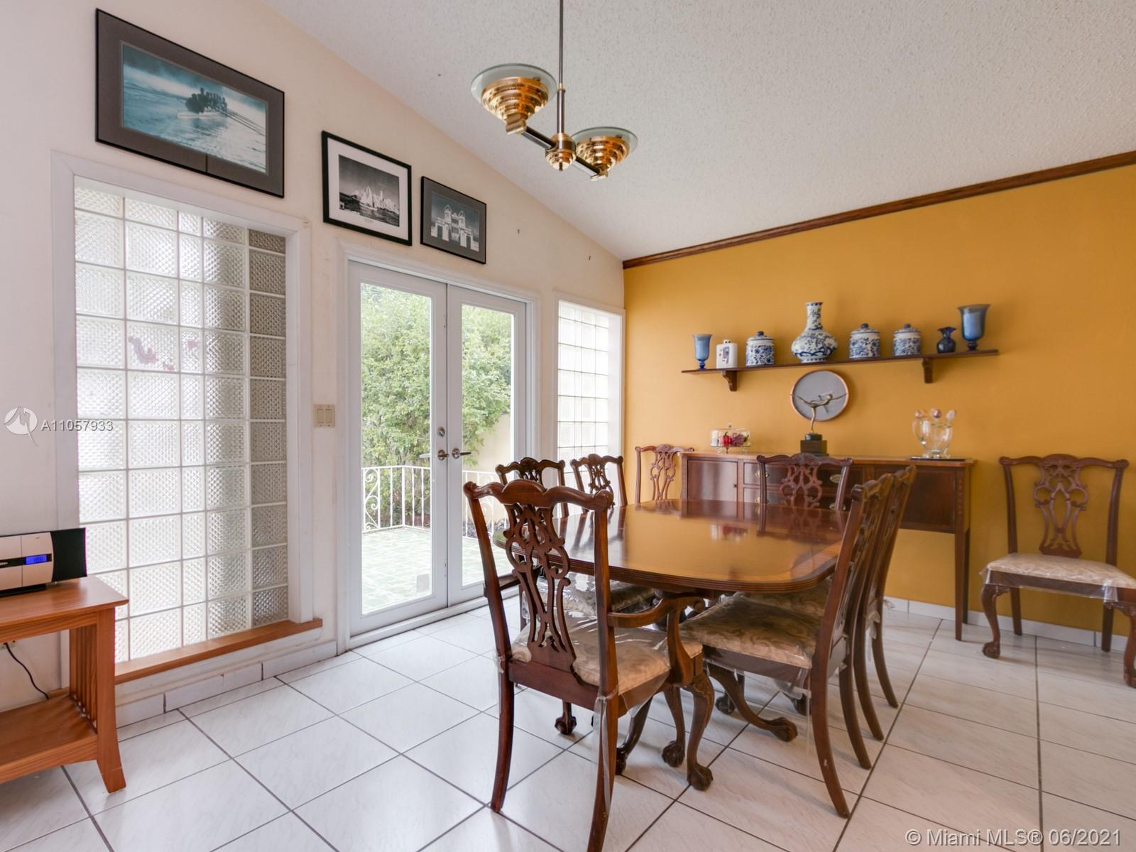 4708 Alton Road Miami Beach, FL 33140 - Photo 35 of 38 a view of a dining room with furniture and a window