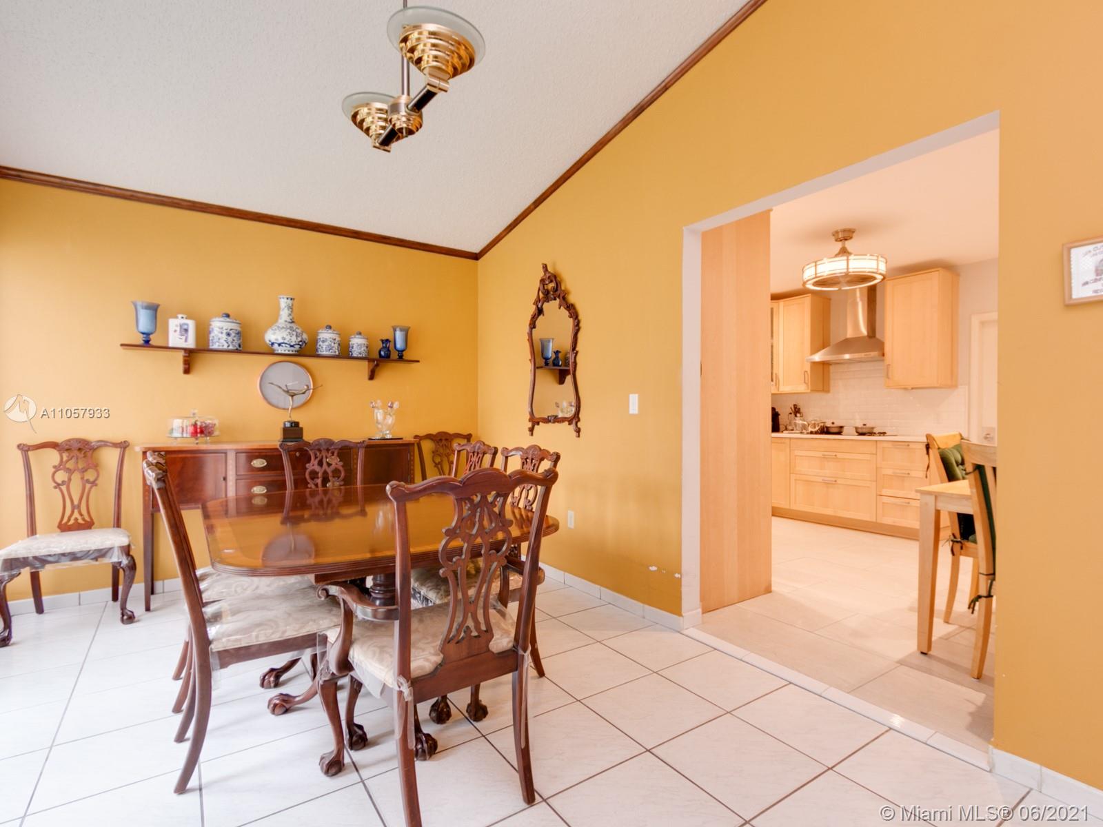 4708 Alton Road Miami Beach, FL 33140 - Photo 36 of 38 a view of a dining room with furniture and wooden floor