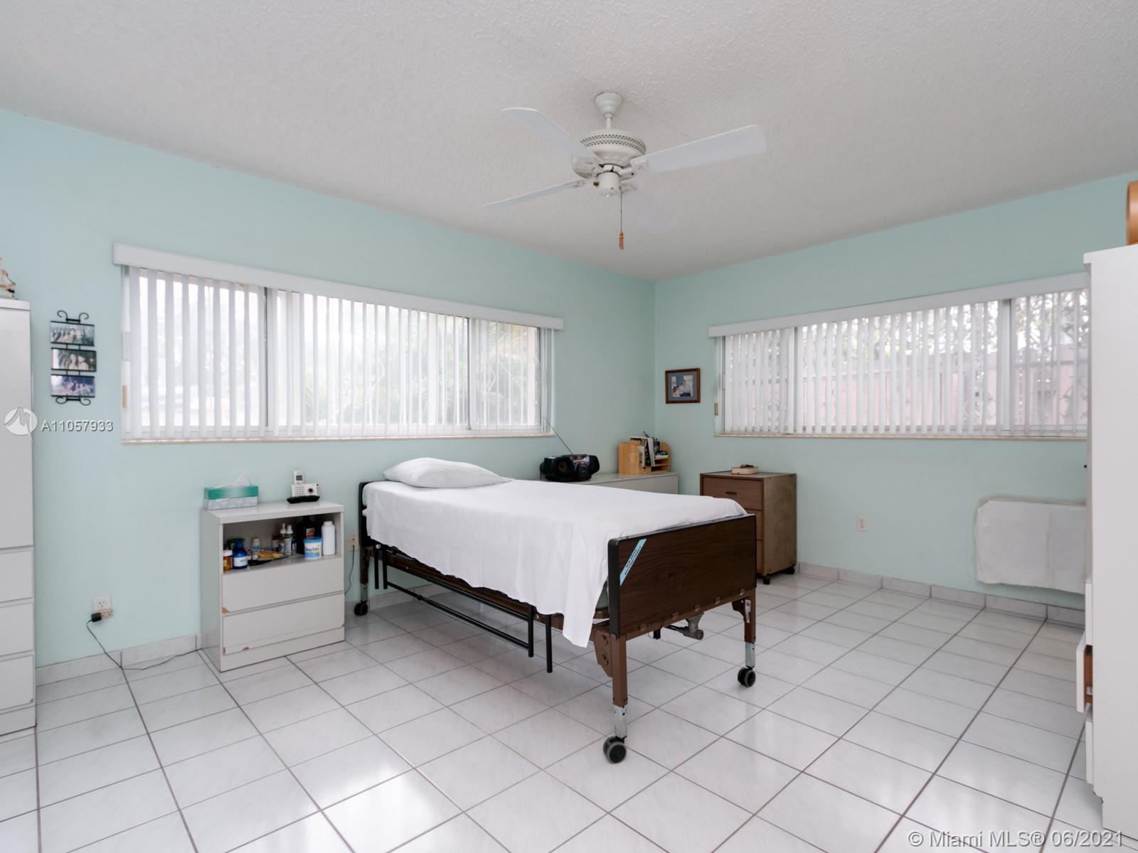 4708 Alton Road Miami Beach, FL 33140 - Photo 8 of 38 a bedroom with a bed and window