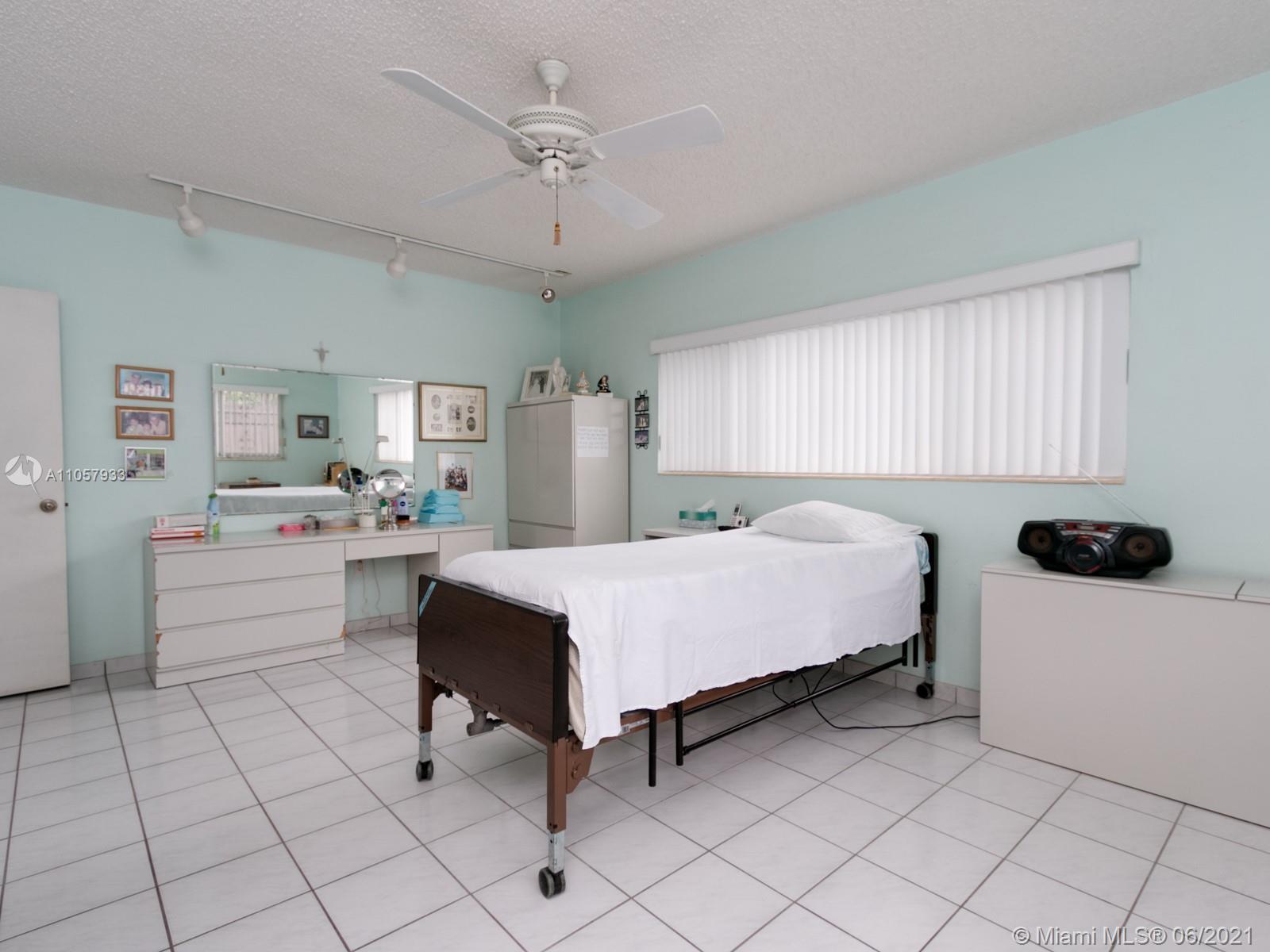 4708 Alton Road Miami Beach, FL 33140 - Photo 10 of 38 a bed room with a bed and a chair