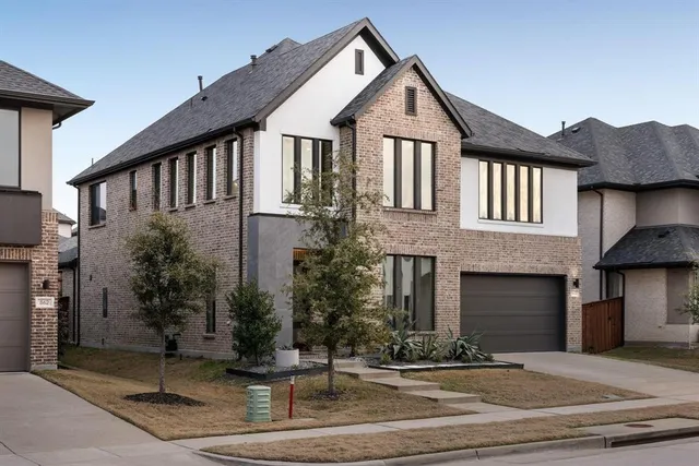 a front view of a house with a yard garage and outdoor seating