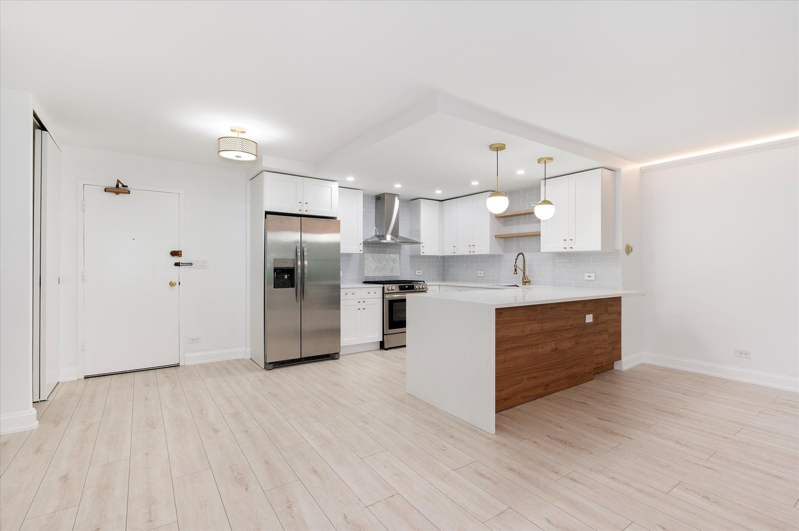 850 North Dewitt Place, Unit 4G Chicago, IL 60611 - Photo 4 of 18 a large kitchen with a wooden floor and stainless steel appliances