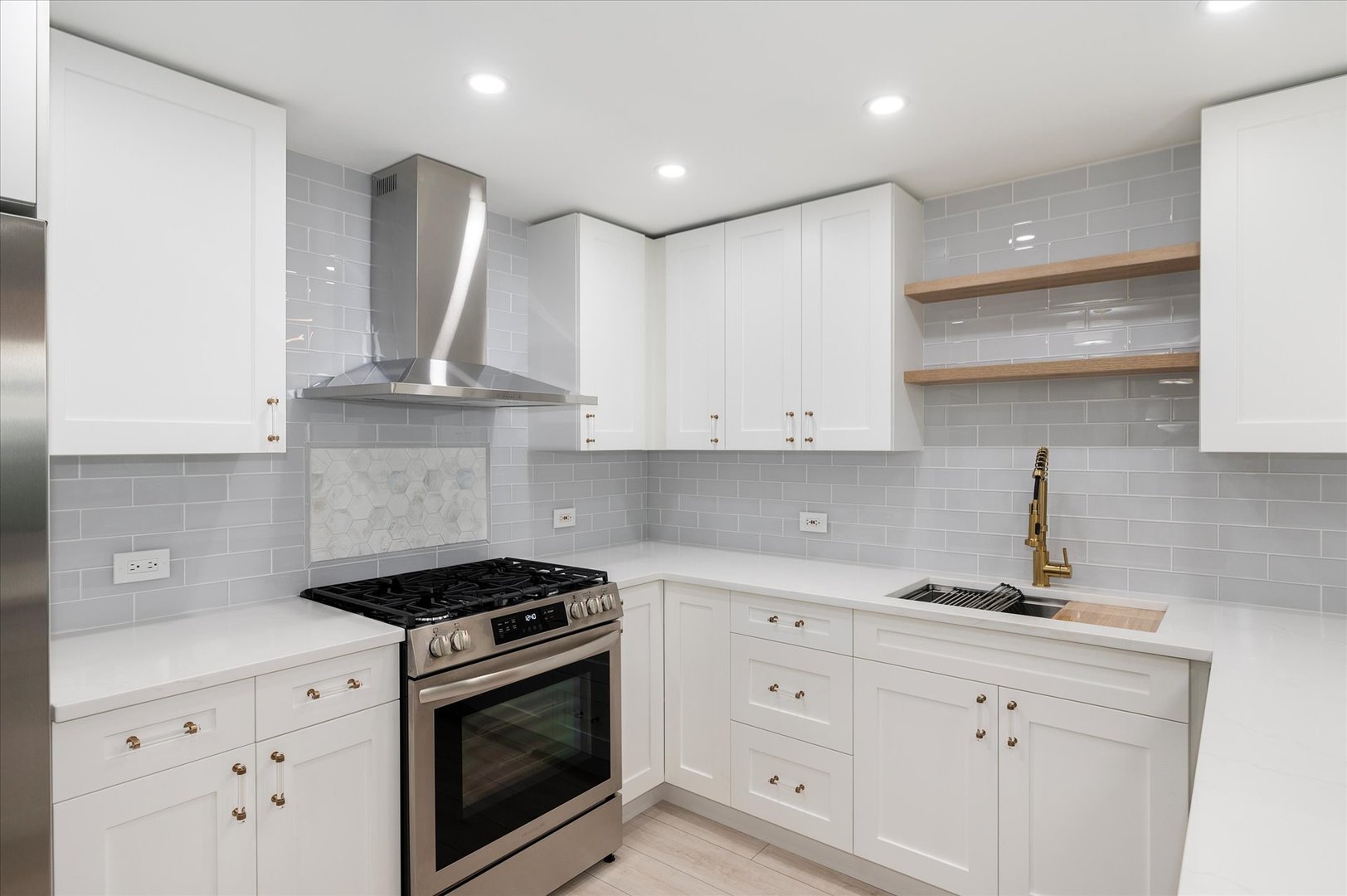 850 North Dewitt Place, Unit 4G Chicago, IL 60611 - Photo 9 of 18 a kitchen with white cabinets and a stove with a sink