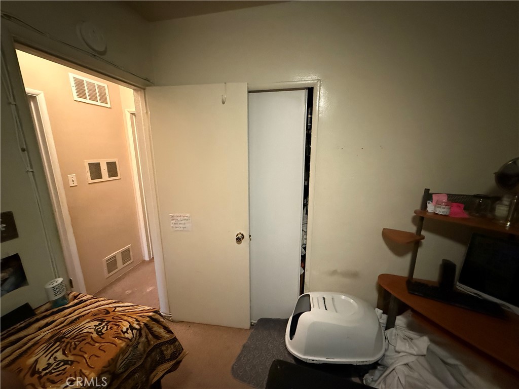 7457 Mt Vernon Street Riverside, CA 92504 - Photo 17 of 23 a bedroom with a bed and a chair