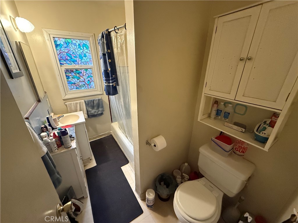 7457 Mt Vernon Street Riverside, CA 92504 - Photo 19 of 23 a white toilet sitting next to a bathroom sink
