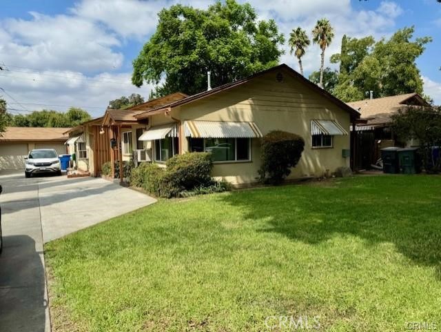 7457 Mt Vernon Street Riverside, CA 92504 - Photo 2 of 23 a front view of a house with garden