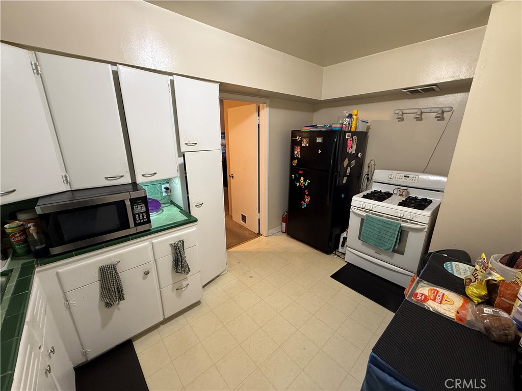 7457 Mt Vernon Street Riverside, CA 92504 - Photo 22 of 23 a view of walk in closet with clothes and shoes