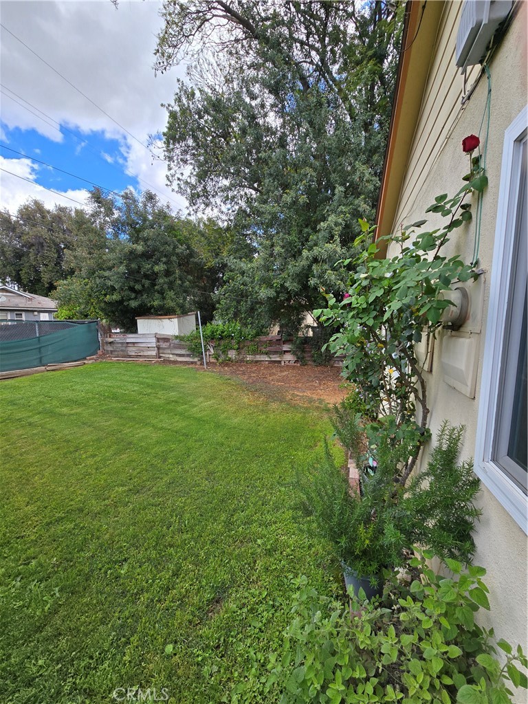 7457 Mt Vernon Street Riverside, CA 92504 - Photo 4 of 23 a view of a house with a yard