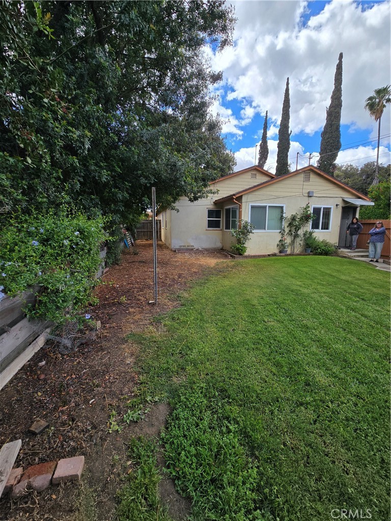 7457 Mt Vernon Street Riverside, CA 92504 - Photo 5 of 23 a white house that has a tree in front of it