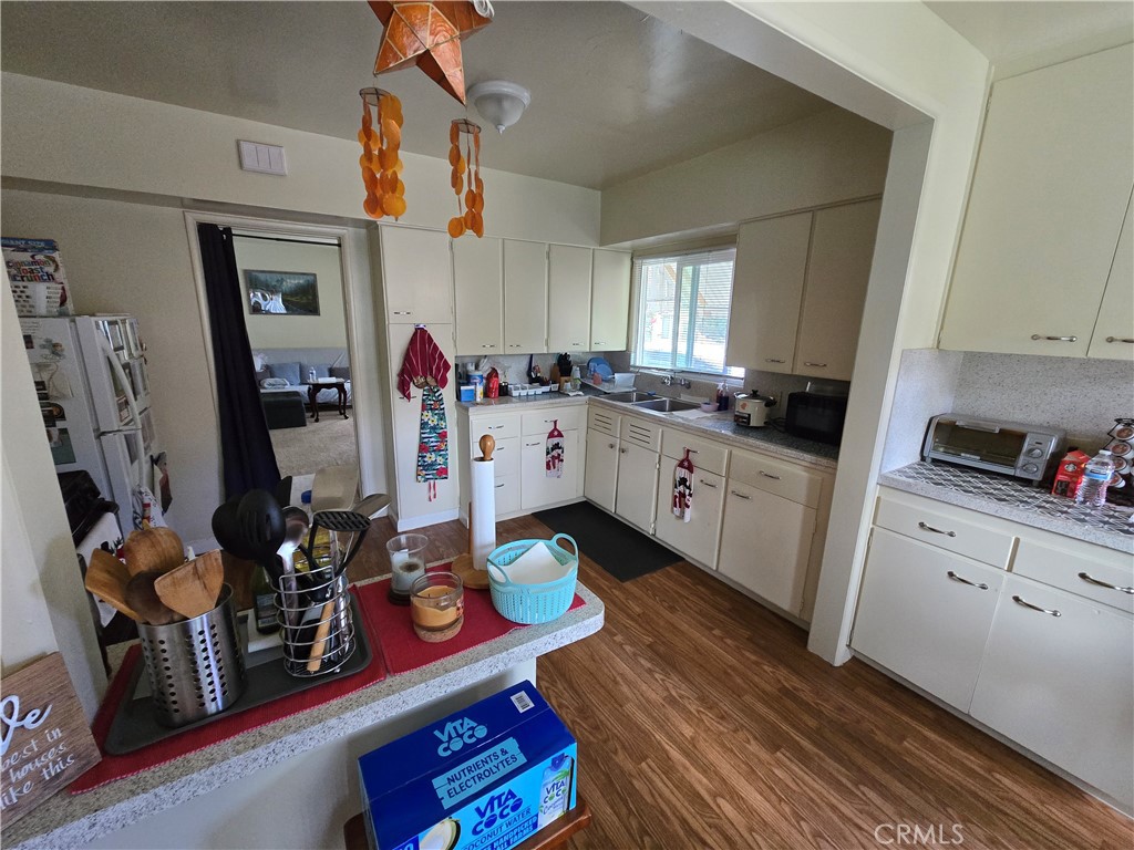 7457 Mt Vernon Street Riverside, CA 92504 - Photo 6 of 23 a kitchen with stainless steel appliances granite countertop a sink dishwasher stove and cabinets